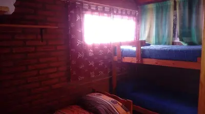 a bedroom with two bunk beds and a window at Doña Elba in Merlo