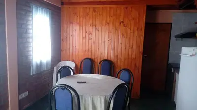 a table in a room with a table and four chairs at Doña Elba in Merlo
