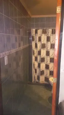 a bathroom with a glass shower with a toilet at Doña Elba in Merlo