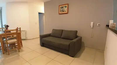 a living room with a chair and a table at Mi Espacio Departamento en Alta Gracia in Alta Gracia