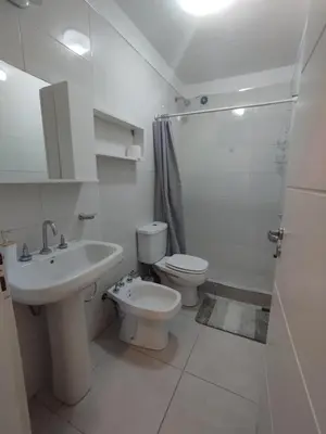 a bathroom with a toilet and a sink and a shower at Mi Espacio Departamento en Alta Gracia in Alta Gracia
