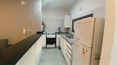 a kitchen with a white refrigerator and a stove at Mi Espacio Departamento en Alta Gracia in Alta Gracia