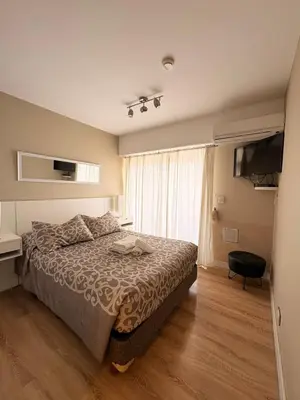 a bedroom with a bed and a television in it at Departamento 8 Villa Carlos Paz in Villa Carlos Paz
