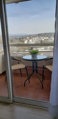 a table and chairs on a balcony with a view at Departamento 8 Villa Carlos Paz in Villa Carlos Paz