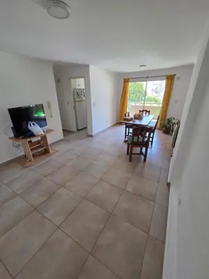 a living room with a tiled floor and a dining room at Depto Completo 1 Hab Gral Paz in Cordoba