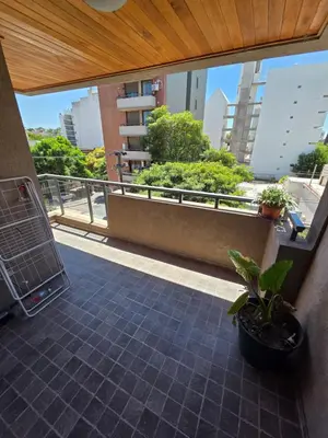 a balcony with a view of a building with plants at Depto Completo 1 Hab Gral Paz in Cordoba