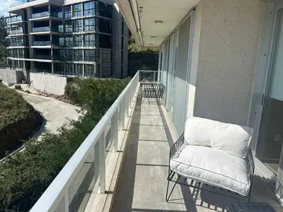 a chair sitting on the balcony of a building at departamento en Lago Los Molinos in Villa Ciudad de America