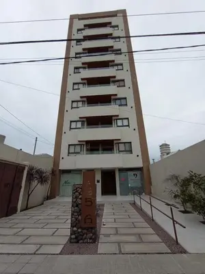 a tall building with a sign in front of it at Home Rio Cuarto 
