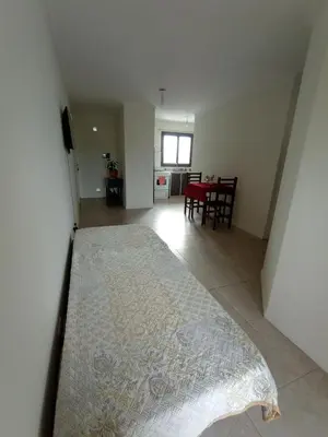a living room with a large bed and a dining room at Home Rio Cuarto 