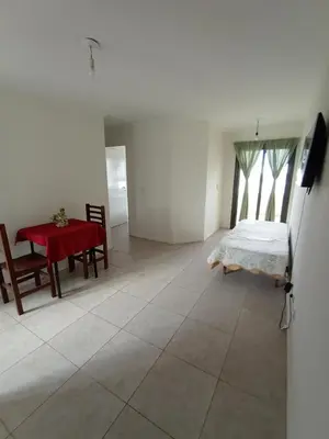 a room with a table and a bed and a table and chairs at Home Rio Cuarto 