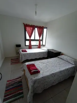 a bedroom with three beds and a window at Home Rio Cuarto 
