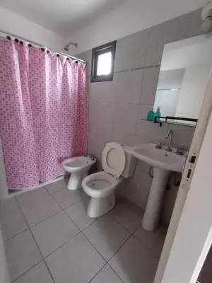 a bathroom with a toilet and a sink at Home Rio Cuarto 