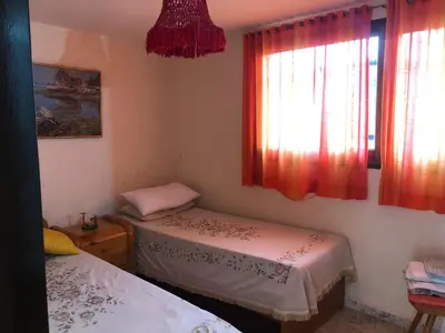 a room with two beds and a window at Casa en Villa del dique con piscina ideal p dos familias in Villa del Dique