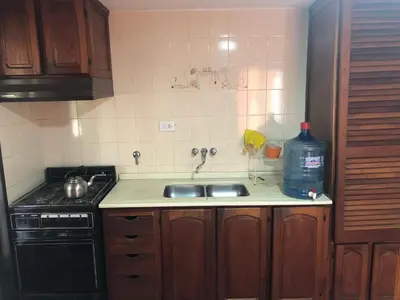 a kitchen with a sink and a bottle of water at Casa en Villa del dique con piscina ideal p dos familias in Villa del Dique