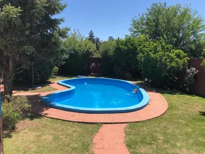 a small pool in a yard with a brick walkway around it at Casa en Villa del dique con piscina ideal p dos familias in Villa del Dique