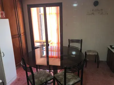 a dining room with a glass table and chairs at Casa en Villa del dique con piscina ideal p dos familias in Villa del Dique