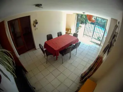 a dining room with a red table and chairs at Casa en Villa del dique con piscina ideal p dos familias in Villa del Dique
