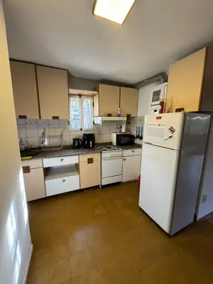 a kitchen with white appliances and a white refrigerator at Patio Serrano - Casa privada en planta baja in Villa Carlos Paz