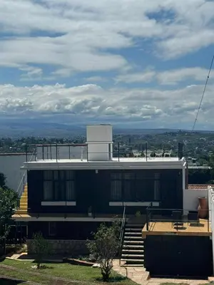 a building with a balcony and stairs on top of it at Patio Serrano - Casa privada en planta baja in Villa Carlos Paz