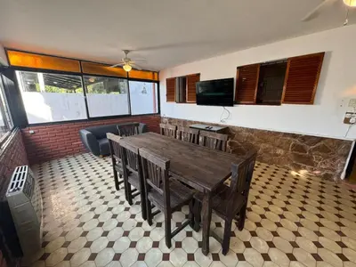 a dining room with a wooden table and chairs at Patio Serrano - Casa privada en planta baja in Villa Carlos Paz