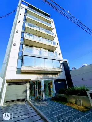 a tall white building with a lot of windows at Home Rio Cuarto 