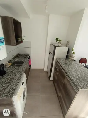 a kitchen with a sink and a stove top oven at Home Rio Cuarto 
