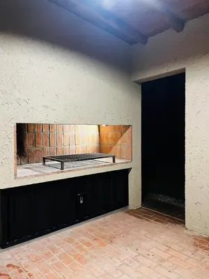 an empty room with a black door and a wall at Altos de la Quebrada in Quebrada de los Pozos