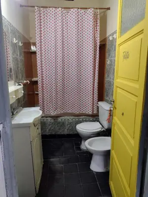 a bathroom with two toilets and a shower curtain at Casona La Ventanita in Mina Clavero