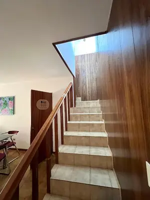 a staircase in a house with wooden walls at Casa con pileta in Villa Carlos Paz