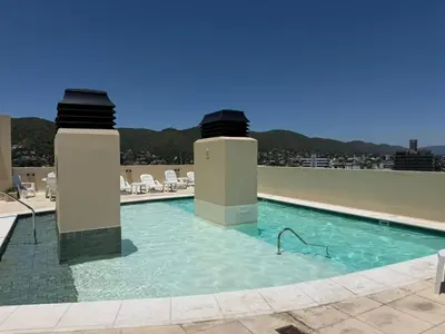 a swimming pool on the roof of a building at Torre Melos Carlos Paz in Villa Carlos Paz