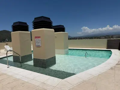 a swimming pool on top of a building at Torre Melos Carlos Paz in Villa Carlos Paz