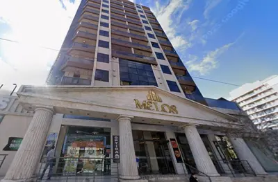 a building with a mens store in front of it at Torre Melos Carlos Paz in Villa Carlos Paz