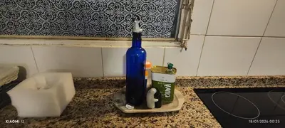 a blue bottle sitting on top of a counter at little house between mountains in Villa Carlos Paz