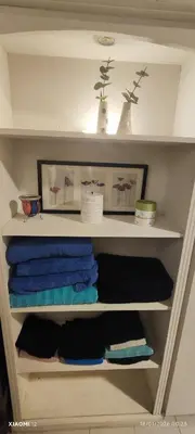 a closet with some towels on a shelf at little house between mountains in Villa Carlos Paz