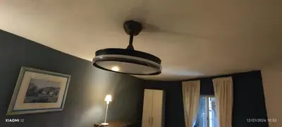 a light hanging from a ceiling in a room at little house between mountains in Villa Carlos Paz