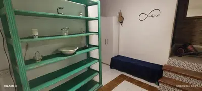 a bathroom with green shelves with a sink and a mirror at little house between mountains in Villa Carlos Paz