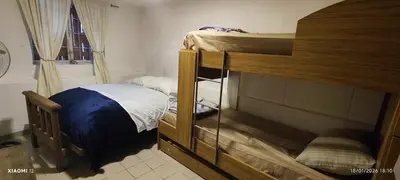 a bedroom with a bunk bed with a ladder to the top at little house between mountains in Villa Carlos Paz