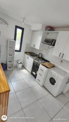 a kitchen with a stove and a washing machine at Carmen alojamientos in Cordoba