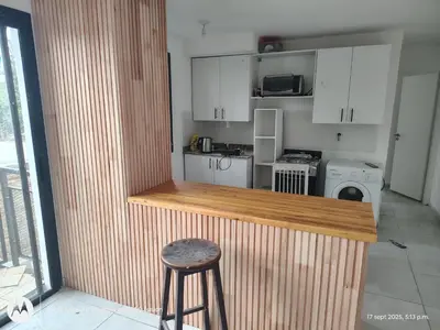 a kitchen with a counter and a stool in a room at Carmen alojamientos in Cordoba
