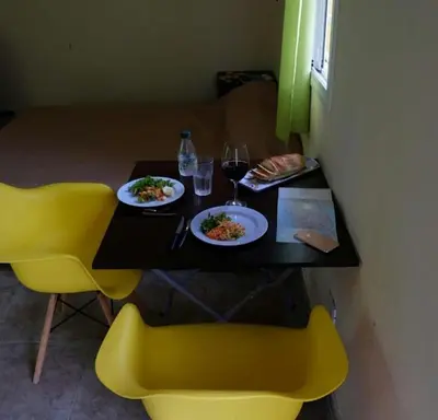 a table with two plates of food and glasses of wine at Urquiza 1 in Pilar