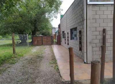a side of a building with a fence next to it at Urquiza 1 in Pilar