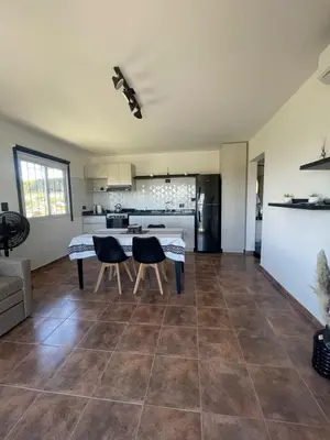 a kitchen and living room with a table and chairs at Bella Vista in Villa Carlos Paz
