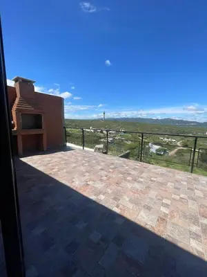 a large patio with a view of a field at Bella Vista in Villa Carlos Paz
