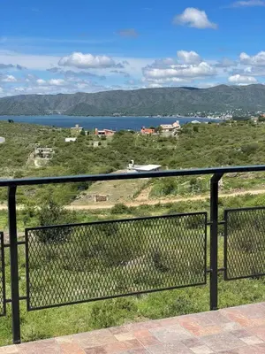 a view of the water from the balcony of a house at Bella Vista in Villa Carlos Paz