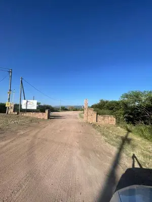 an empty dirt road with a bridge in the distance at Bella Vista in Villa Carlos Paz