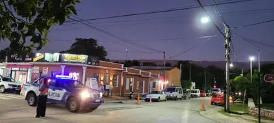 a police truck driving down a street at night at Fuego in Nono
