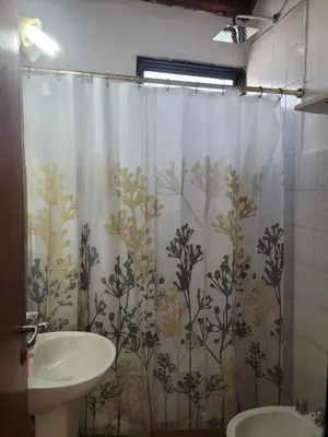 a bathroom with a sink and a shower curtain at Fuego in Nono