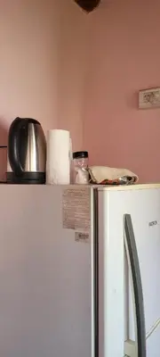 a refrigerator in a kitchen with a counter on top of it at Fuego in Nono