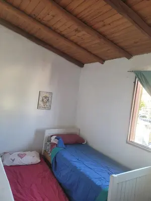 a bedroom with two beds and a window at Fuego in Nono
