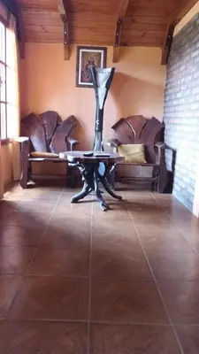 a room with chairs and a table in a room at Cabañas atardecer soñado in Villa Yacanto